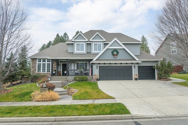 craftsman-style home featuring a garage, covered porch, and a front lawn