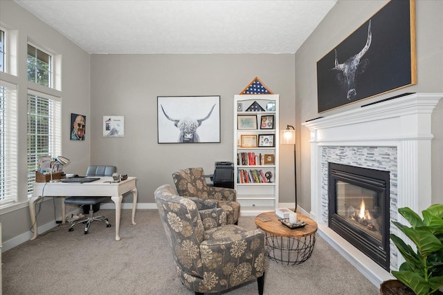 carpeted home office with a fireplace