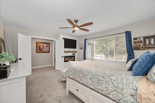 carpeted bedroom featuring a textured ceiling and ceiling fan