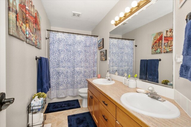 bathroom featuring tile patterned flooring, vanity, and toilet