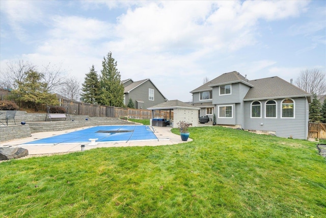 view of pool featuring a lawn and a patio