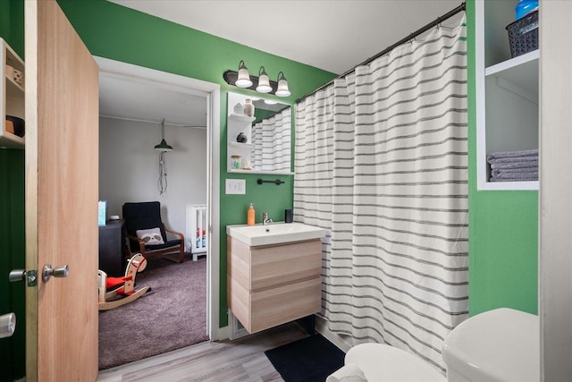 bathroom featuring hardwood / wood-style floors, vanity, and toilet