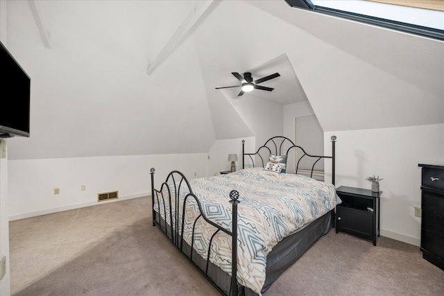 bedroom featuring light carpet, vaulted ceiling with beams, and ceiling fan