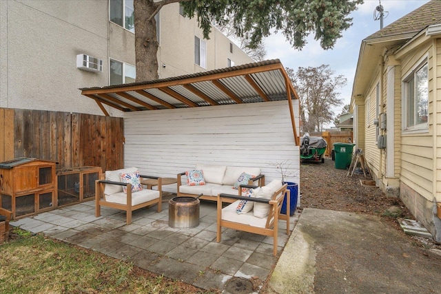 view of patio / terrace featuring an AC wall unit and an outdoor living space