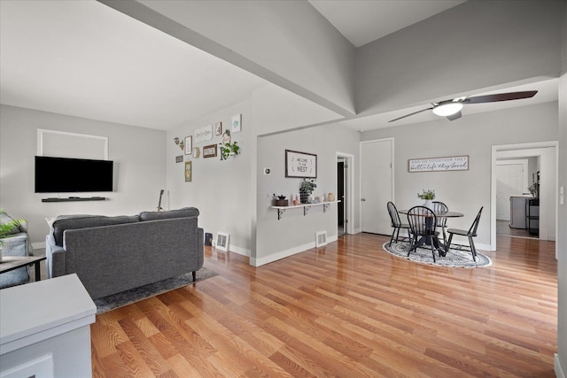 living room with light hardwood / wood-style flooring and ceiling fan