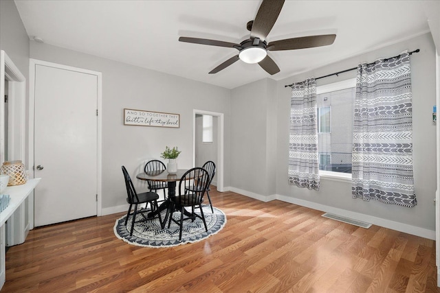 dining room with hardwood / wood-style floors and ceiling fan