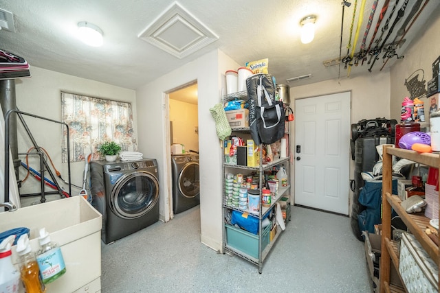 clothes washing area featuring washing machine and dryer and sink