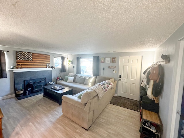 living room featuring a textured ceiling and light hardwood / wood-style flooring