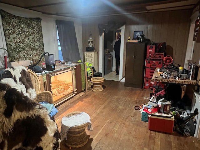 interior space with hardwood / wood-style floors, a workshop area, and wooden walls