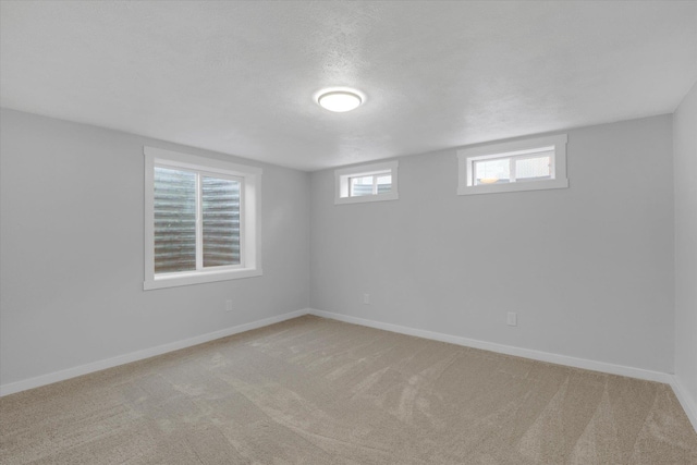 basement with light carpet and a textured ceiling