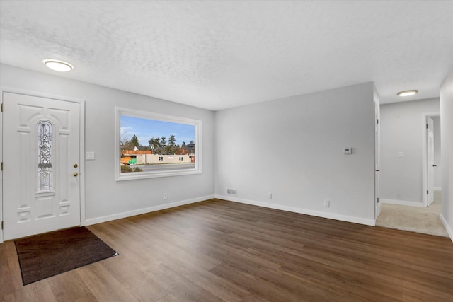 entrance foyer with wood-type flooring and a textured ceiling