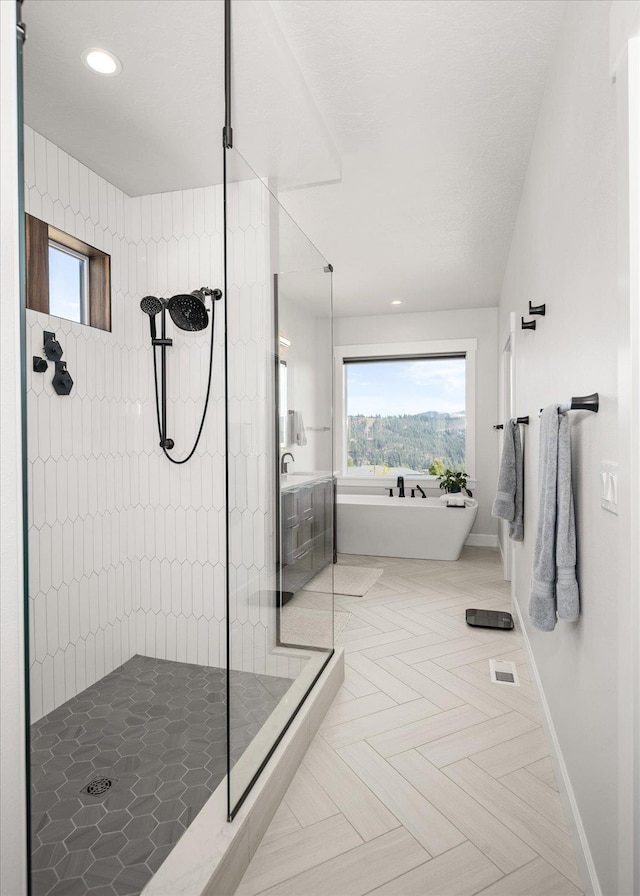 bathroom featuring parquet floors, sink, and plus walk in shower