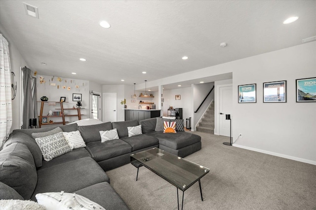 carpeted living room featuring a textured ceiling and plenty of natural light