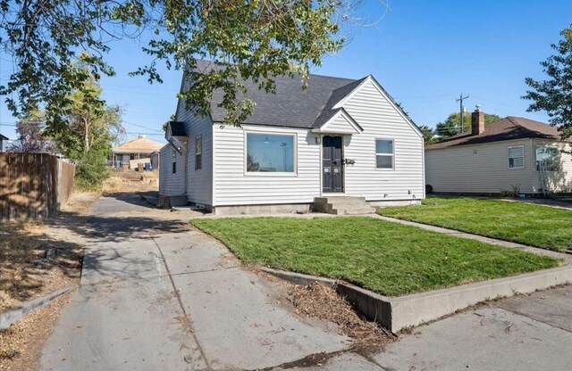 bungalow-style house with a front lawn