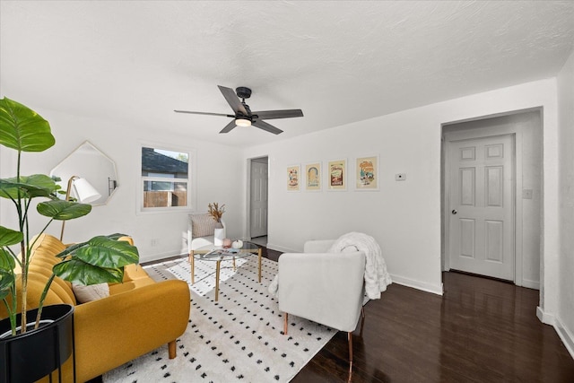 living room featuring dark hardwood / wood-style floors and ceiling fan