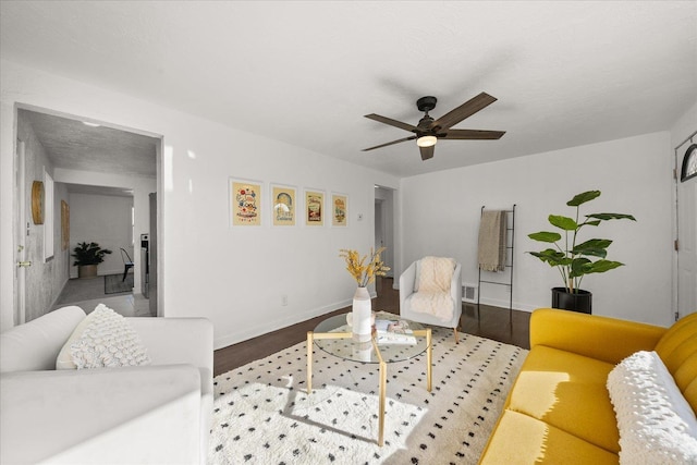 living room with hardwood / wood-style floors, a textured ceiling, and ceiling fan