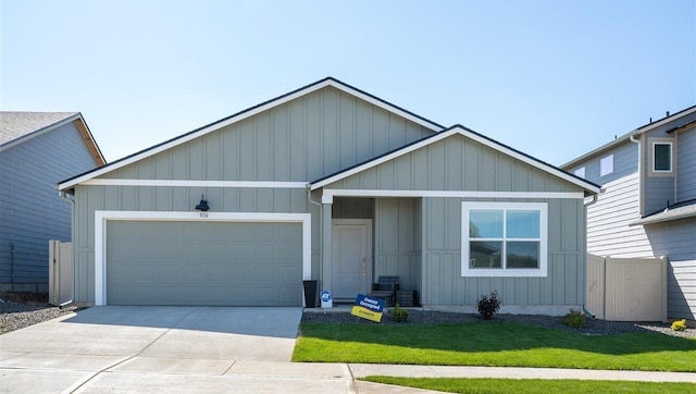 view of front of property featuring a front lawn and a garage