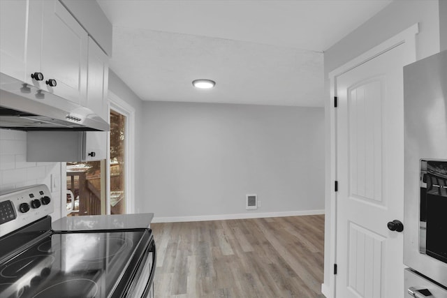 spare room with light hardwood / wood-style floors and a textured ceiling