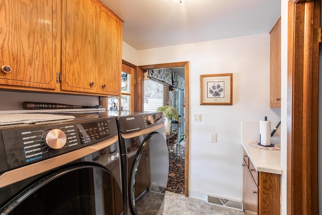 laundry area featuring cabinets and independent washer and dryer