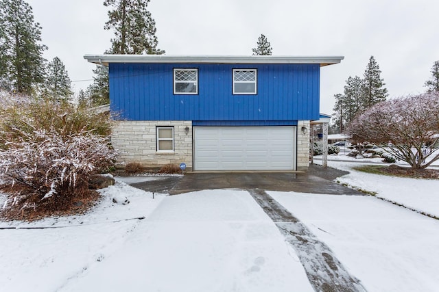 view of snowy exterior with a garage