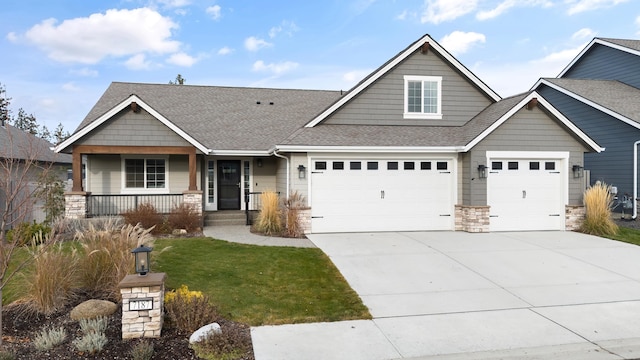 craftsman-style home featuring a front yard, a porch, and a garage