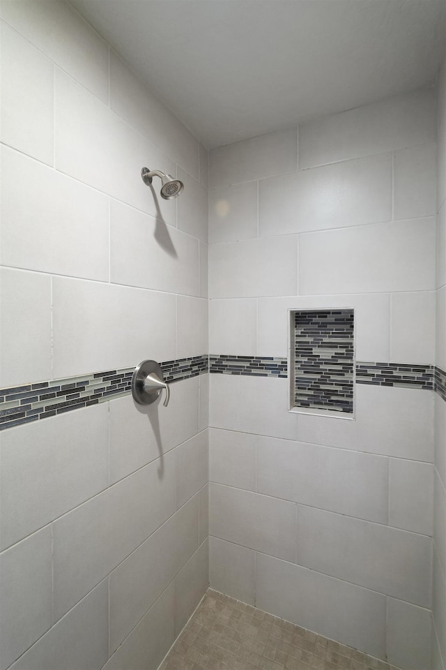 bathroom with a tile shower