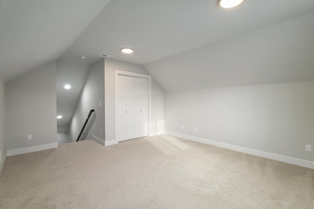 additional living space featuring carpet and lofted ceiling