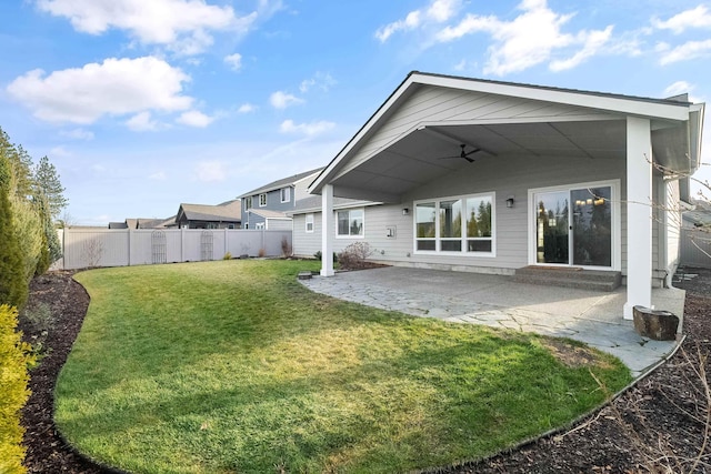 rear view of property with a patio and a lawn