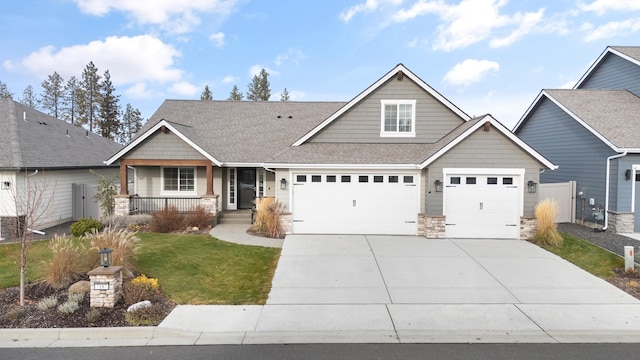 craftsman-style home featuring a porch, a garage, and a front lawn