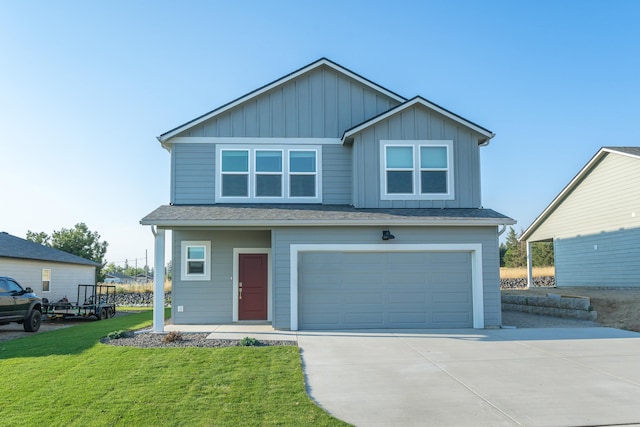 view of front of home featuring a front yard and a garage