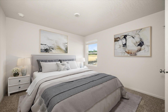 bedroom with carpet flooring and a textured ceiling