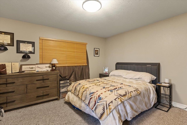 carpeted bedroom with a textured ceiling