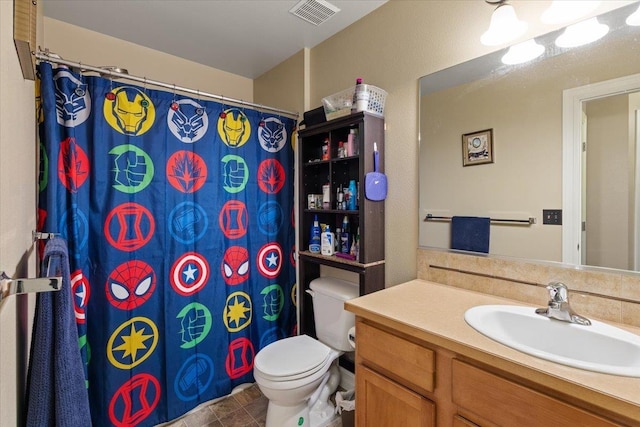 bathroom featuring tile patterned flooring, vanity, and toilet