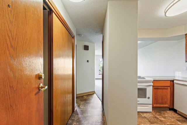 hallway with a textured ceiling