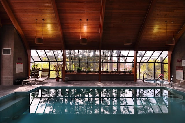 view of swimming pool with glass enclosure and a patio area