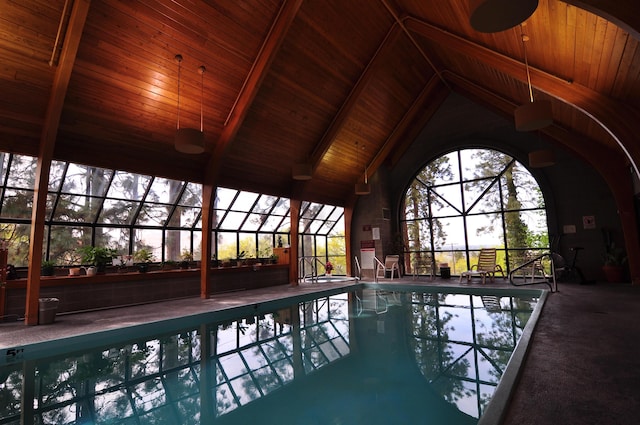 view of swimming pool featuring glass enclosure, ceiling fan, and a patio area