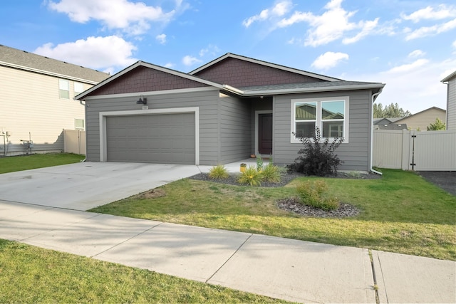 view of front of home featuring a front yard and a garage