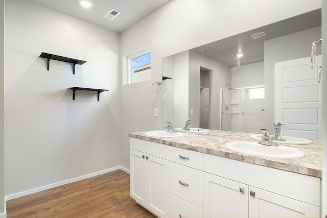 bathroom featuring vanity, a shower with shower door, and hardwood / wood-style flooring