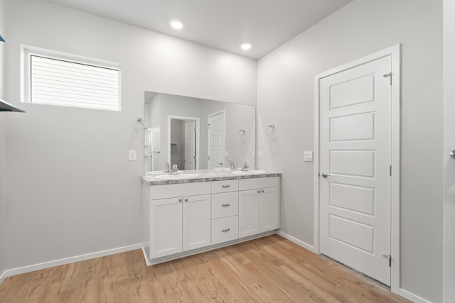 bathroom with hardwood / wood-style floors and vanity