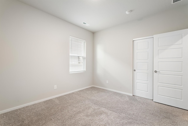 unfurnished bedroom featuring carpet flooring and a closet