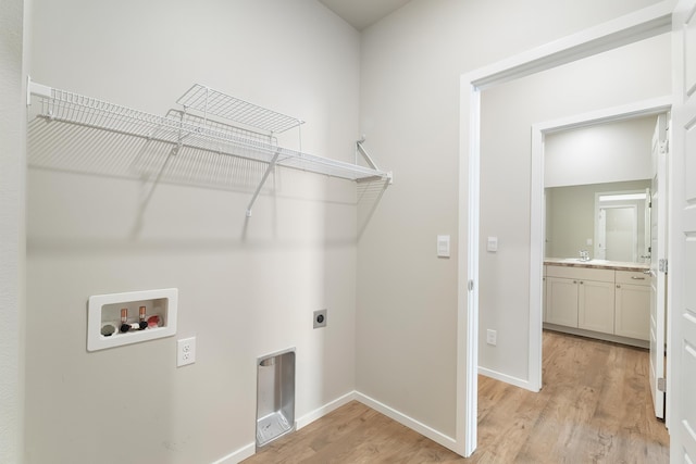 laundry room featuring hookup for an electric dryer, washer hookup, and light wood-type flooring