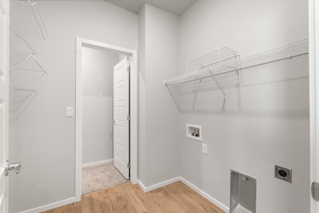 washroom with washer hookup, electric dryer hookup, and wood-type flooring