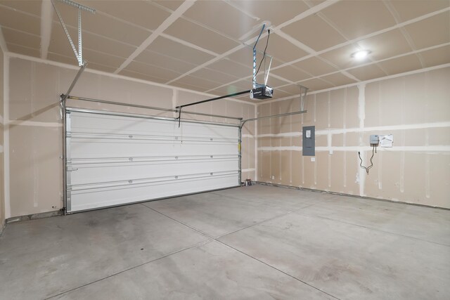 garage with electric panel and a garage door opener