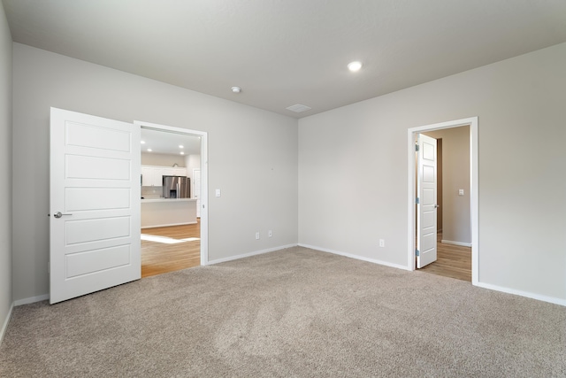 unfurnished room with light carpet