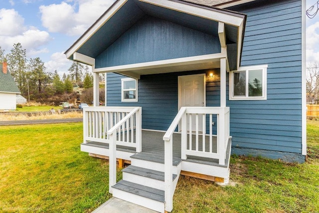 doorway to property featuring a lawn