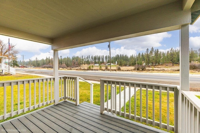 wooden deck with a lawn