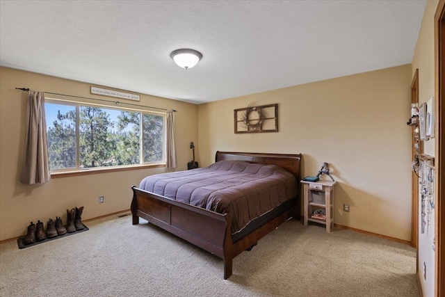 bedroom featuring a textured ceiling and light carpet