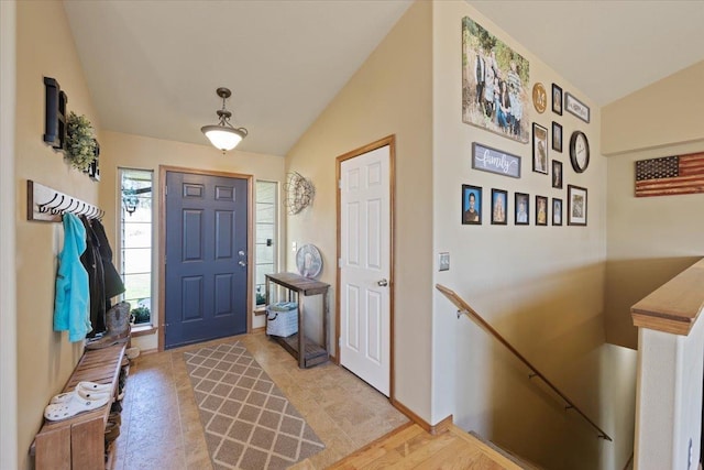 foyer entrance with lofted ceiling and light wood-type flooring