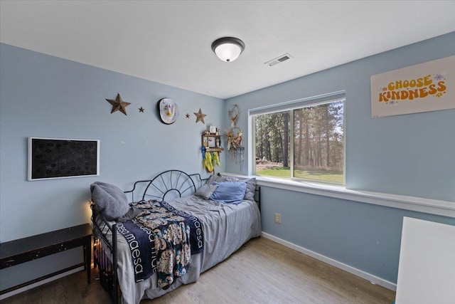 bedroom with hardwood / wood-style flooring