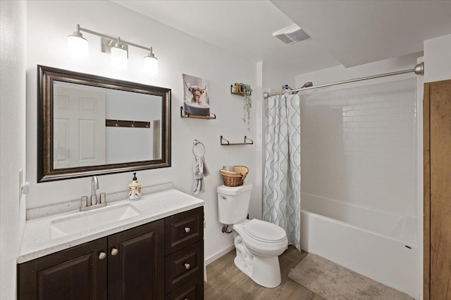 full bathroom featuring vanity, toilet, wood-type flooring, and shower / tub combo